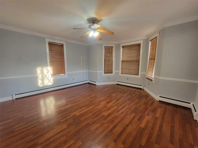 spare room with a baseboard heating unit, ornamental molding, and wood finished floors