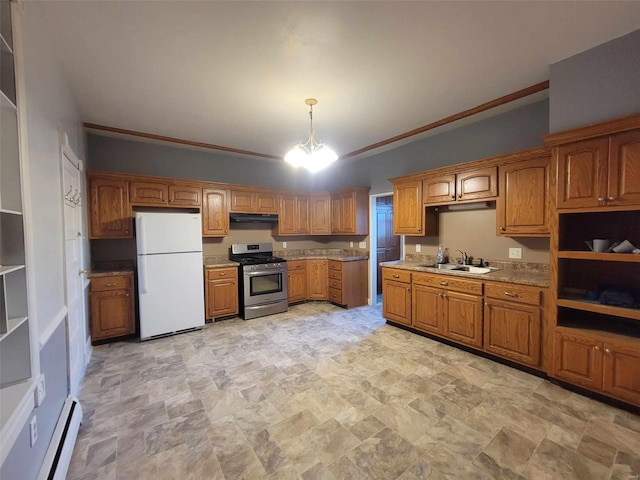 kitchen with stainless steel range with gas stovetop, brown cabinets, freestanding refrigerator, under cabinet range hood, and a sink