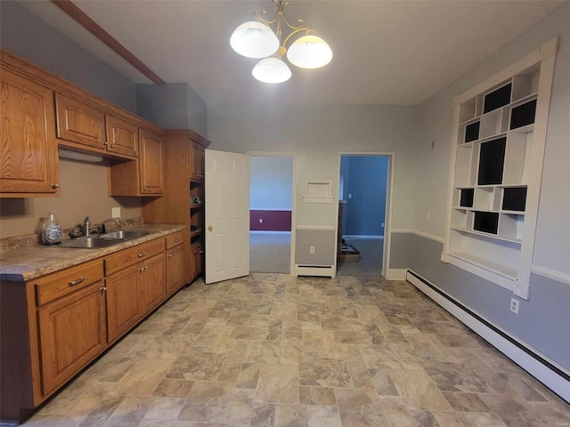 kitchen with a baseboard heating unit, brown cabinets, a sink, and light countertops