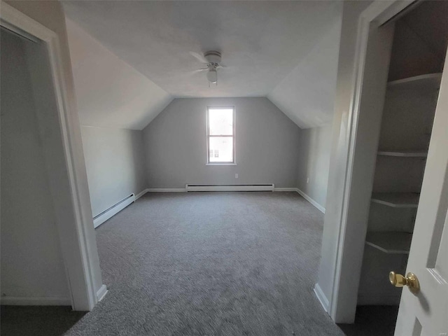 additional living space featuring a baseboard heating unit, lofted ceiling, carpet flooring, and a ceiling fan