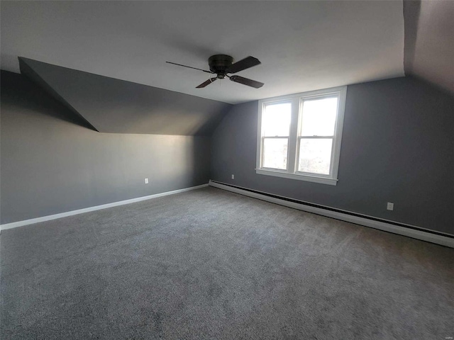 bonus room featuring ceiling fan, a baseboard heating unit, baseboards, vaulted ceiling, and carpet