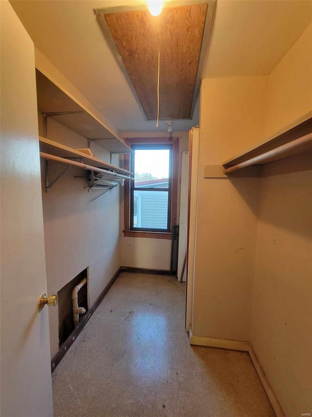 walk in closet featuring attic access