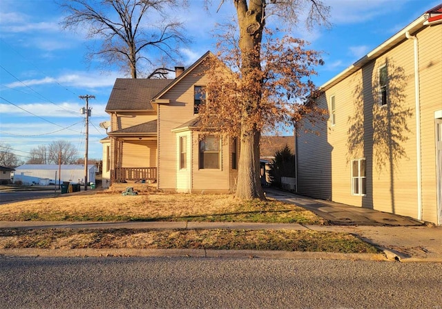 view of front of house featuring a chimney