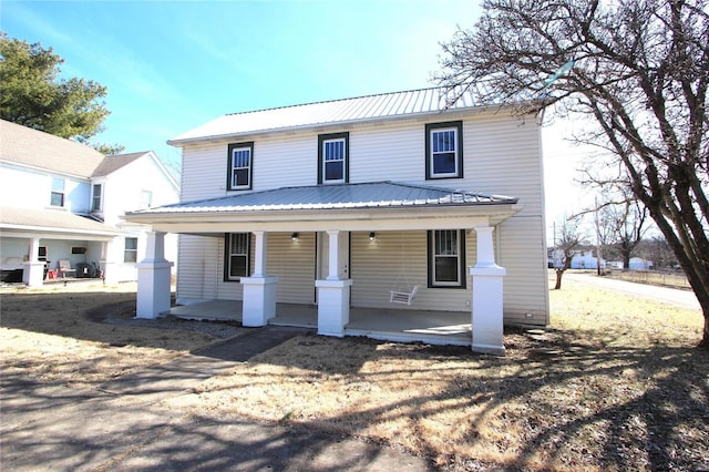 view of front of home with covered porch and metal roof