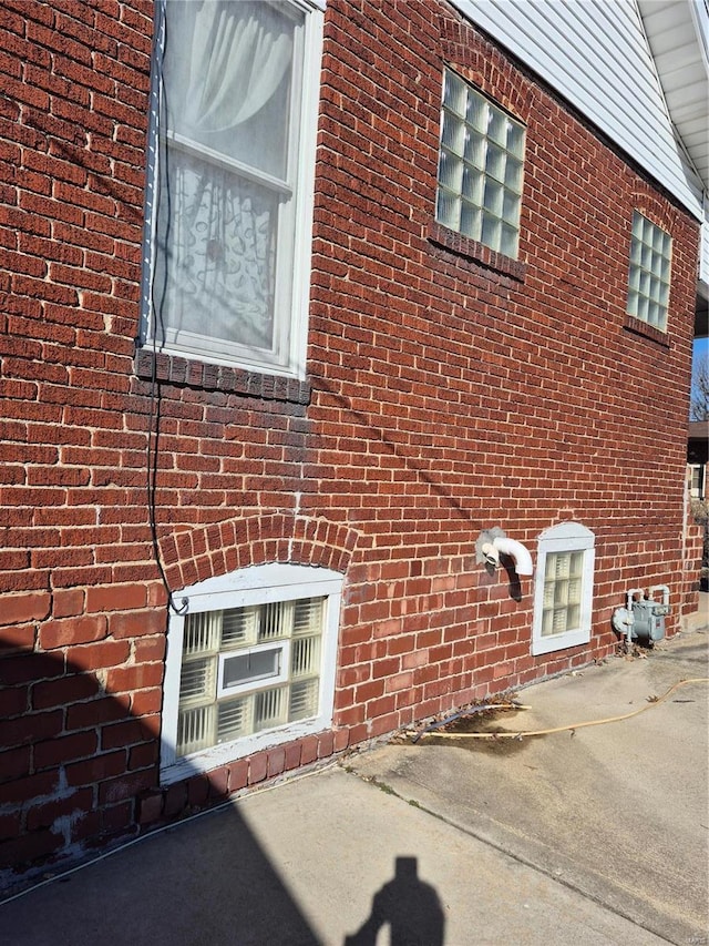 view of property exterior featuring brick siding