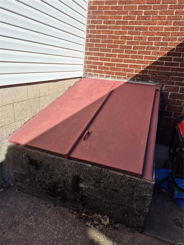 details featuring brick siding and a bulkhead entry