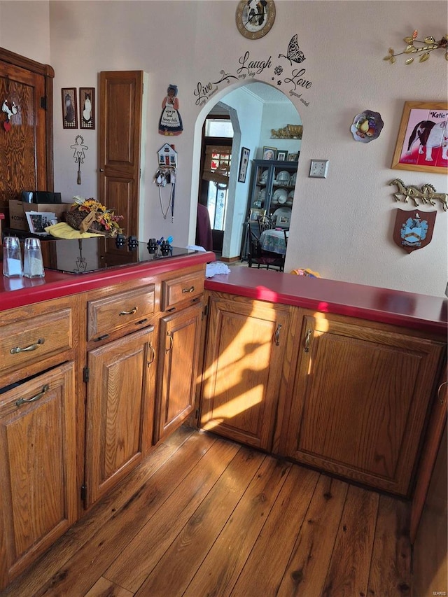 bar featuring arched walkways and hardwood / wood-style flooring