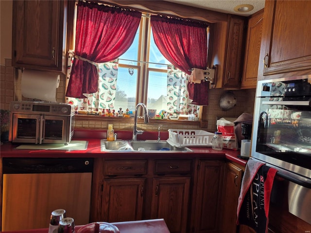 kitchen with stainless steel appliances, tasteful backsplash, and a sink