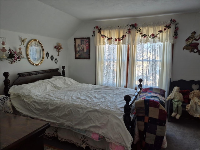 carpeted bedroom with lofted ceiling