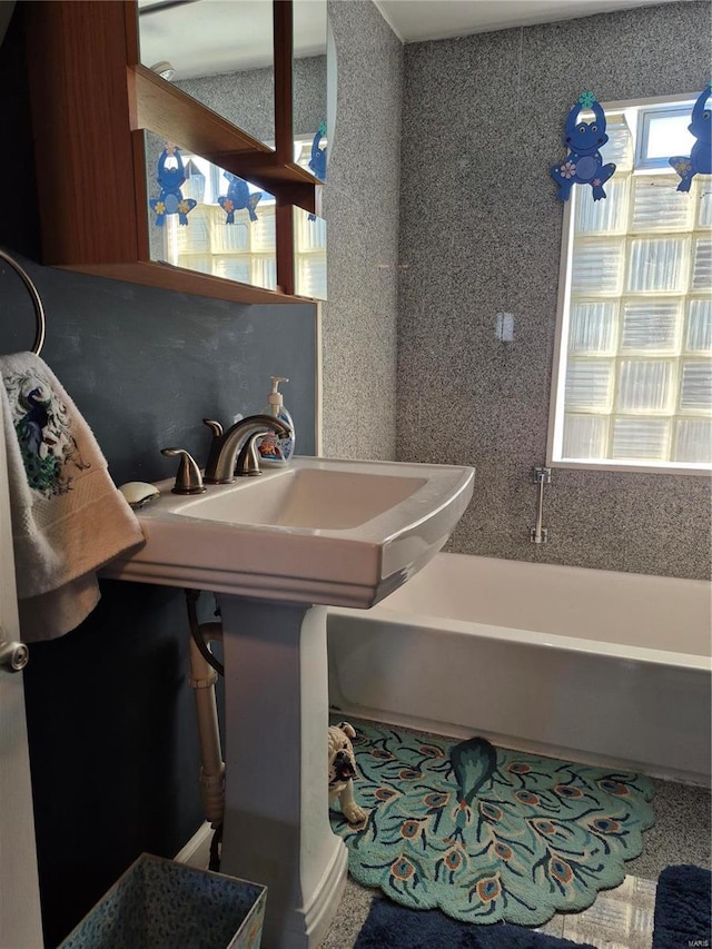 bathroom featuring a tub to relax in