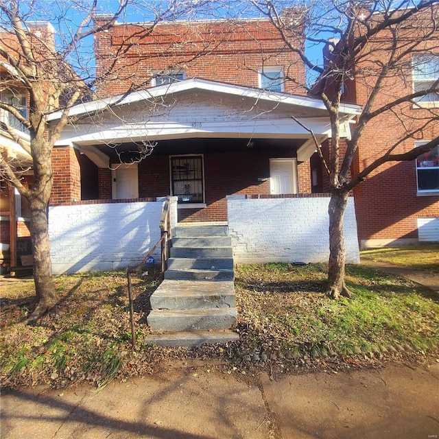 view of front of property featuring a porch and brick siding