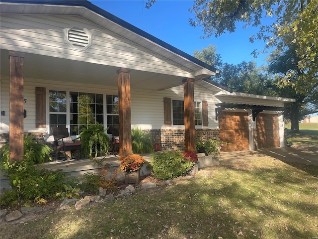 view of side of property featuring a porch and brick siding