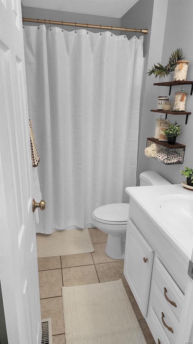 full bath with visible vents, toilet, curtained shower, tile patterned flooring, and vanity