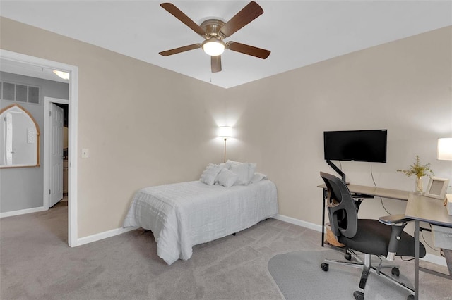 carpeted bedroom featuring a ceiling fan, visible vents, and baseboards