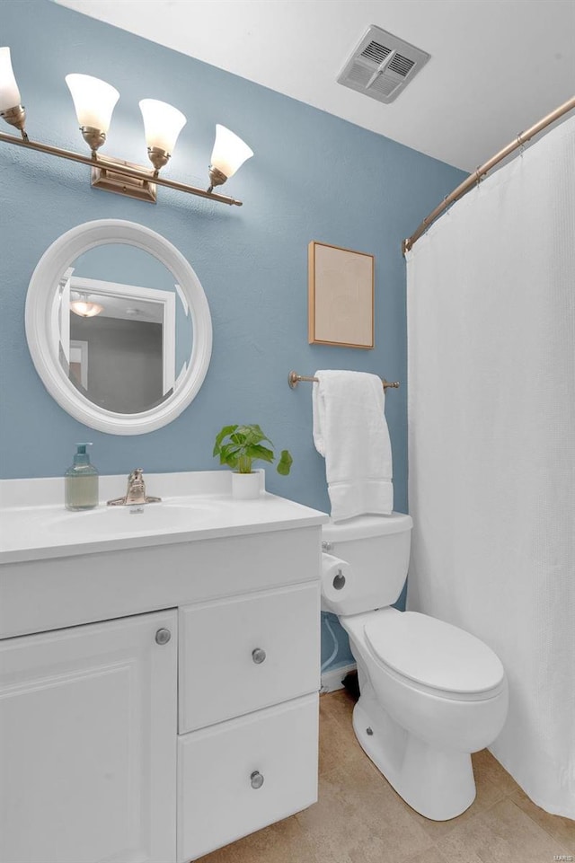 bathroom with visible vents, vanity, and toilet