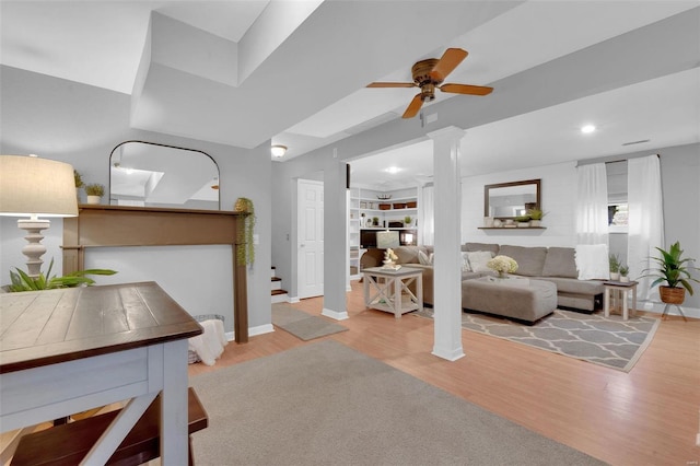 living room with ceiling fan, recessed lighting, wood finished floors, baseboards, and decorative columns