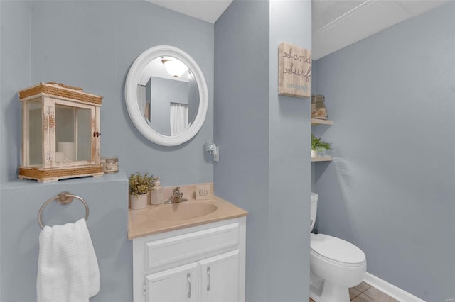 bathroom with vanity, toilet, and tile patterned floors