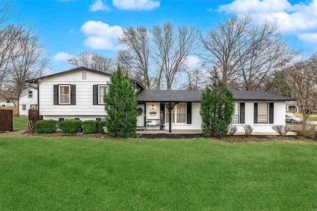 tri-level home featuring a front yard and fence