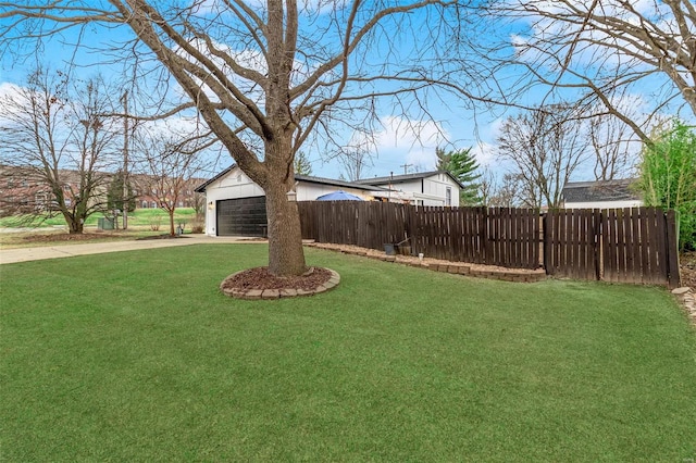 view of yard with fence and driveway