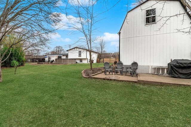 view of yard with a patio area, a barn, and a pool