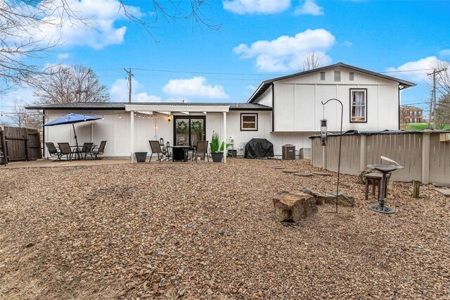 rear view of property featuring a patio, cooling unit, and fence