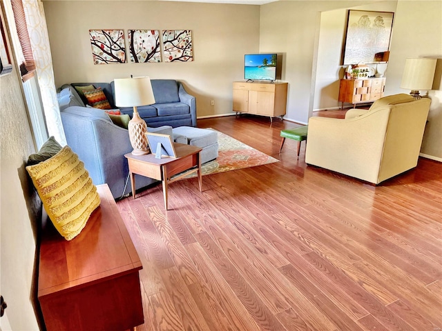 living room featuring wood finished floors and baseboards