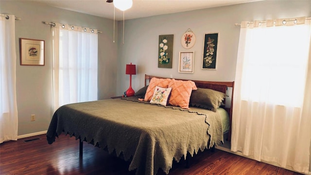 bedroom featuring wood finished floors, visible vents, and baseboards