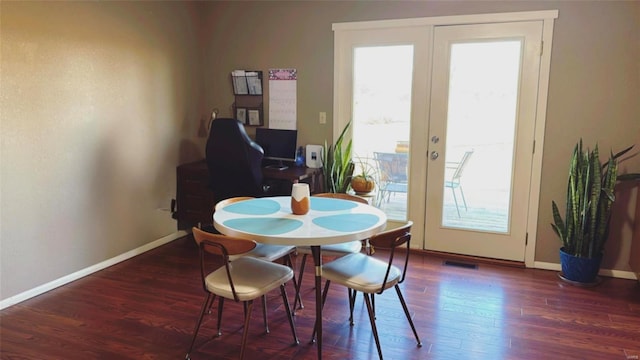 dining space featuring baseboards, wood finished floors, and french doors