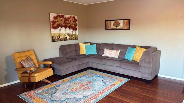 living area with baseboards and wood finished floors