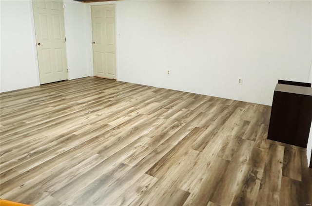 spare room featuring wood finished floors