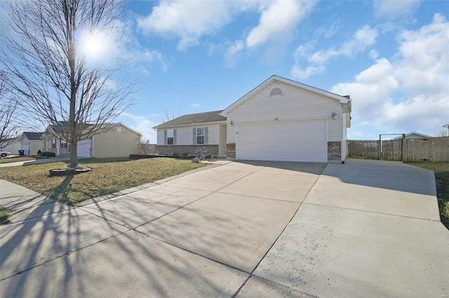 ranch-style house featuring driveway, fence, a front yard, a garage, and brick siding