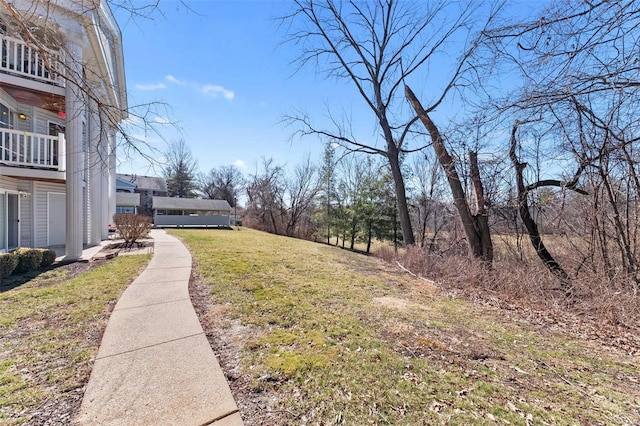 view of yard with a balcony