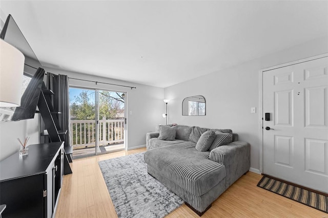 living room featuring light wood finished floors and baseboards