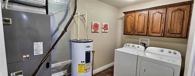 clothes washing area featuring electric water heater, baseboards, independent washer and dryer, cabinet space, and dark wood finished floors