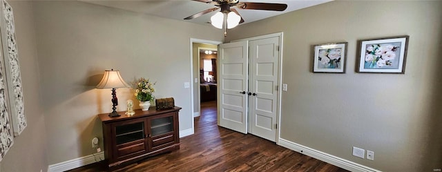 interior space with baseboards and dark wood-style flooring