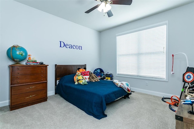 carpeted bedroom featuring ceiling fan and baseboards