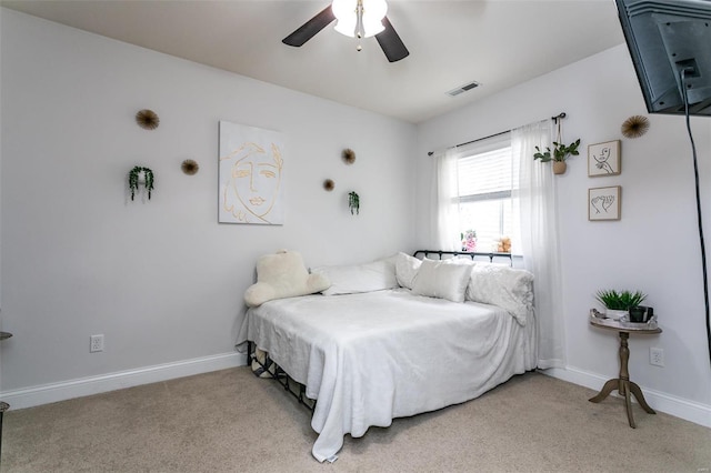 carpeted bedroom with visible vents, ceiling fan, and baseboards