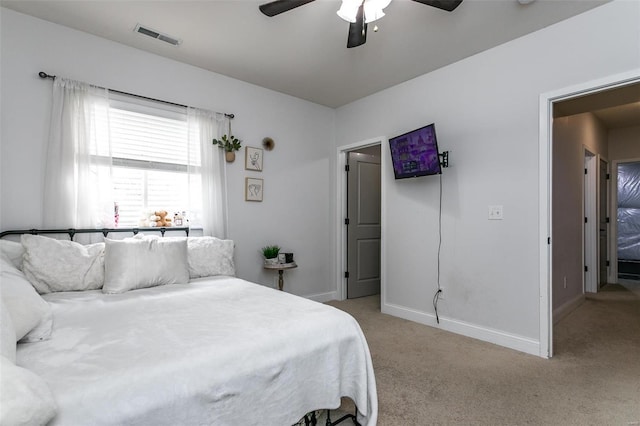 bedroom with light carpet, baseboards, visible vents, and ceiling fan