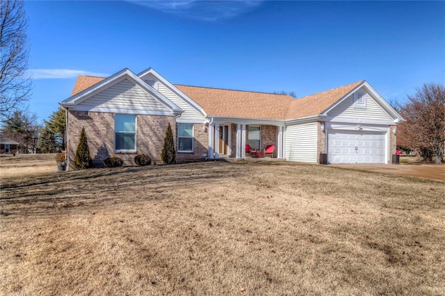 ranch-style home with driveway, a shingled roof, an attached garage, a front yard, and brick siding