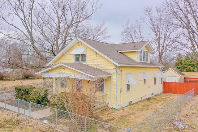 view of property exterior with a fenced front yard and roof with shingles