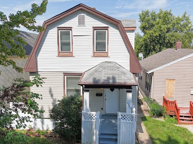 view of front facade with a shingled roof and a gambrel roof