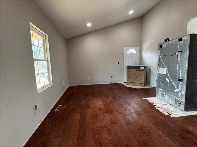 interior space with baseboards, visible vents, wood finished floors, vaulted ceiling, and recessed lighting