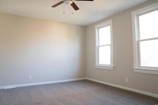 unfurnished room with carpet, ceiling fan, and baseboards