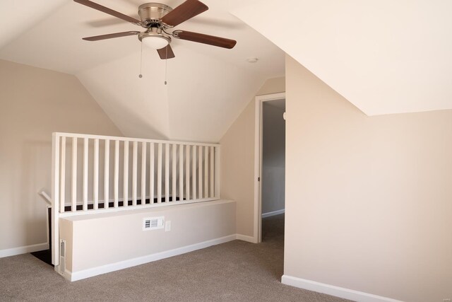 additional living space featuring lofted ceiling, carpet flooring, ceiling fan, and baseboards