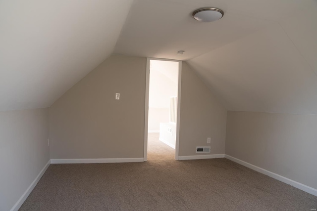 bonus room with carpet, baseboards, visible vents, and vaulted ceiling