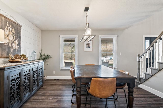 dining space featuring stairs, baseboards, and dark wood-style flooring