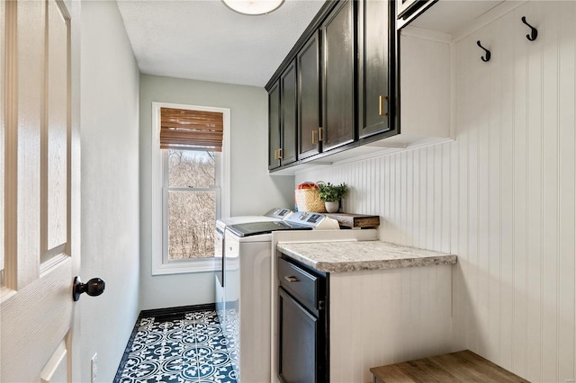 laundry room featuring cabinet space, tile patterned flooring, and washing machine and clothes dryer