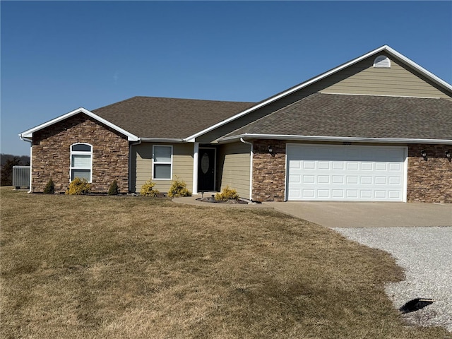 single story home featuring an attached garage, driveway, a shingled roof, and a front yard