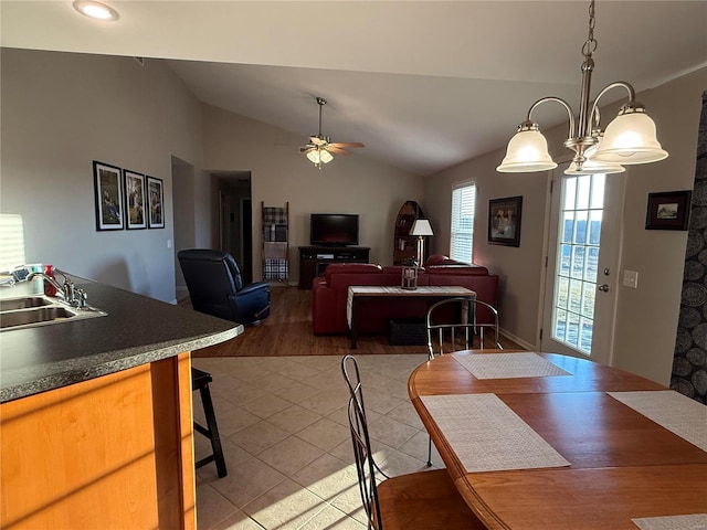 dining room featuring lofted ceiling, a ceiling fan, and wood finished floors