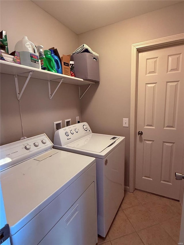 washroom featuring laundry area, light tile patterned floors, and separate washer and dryer